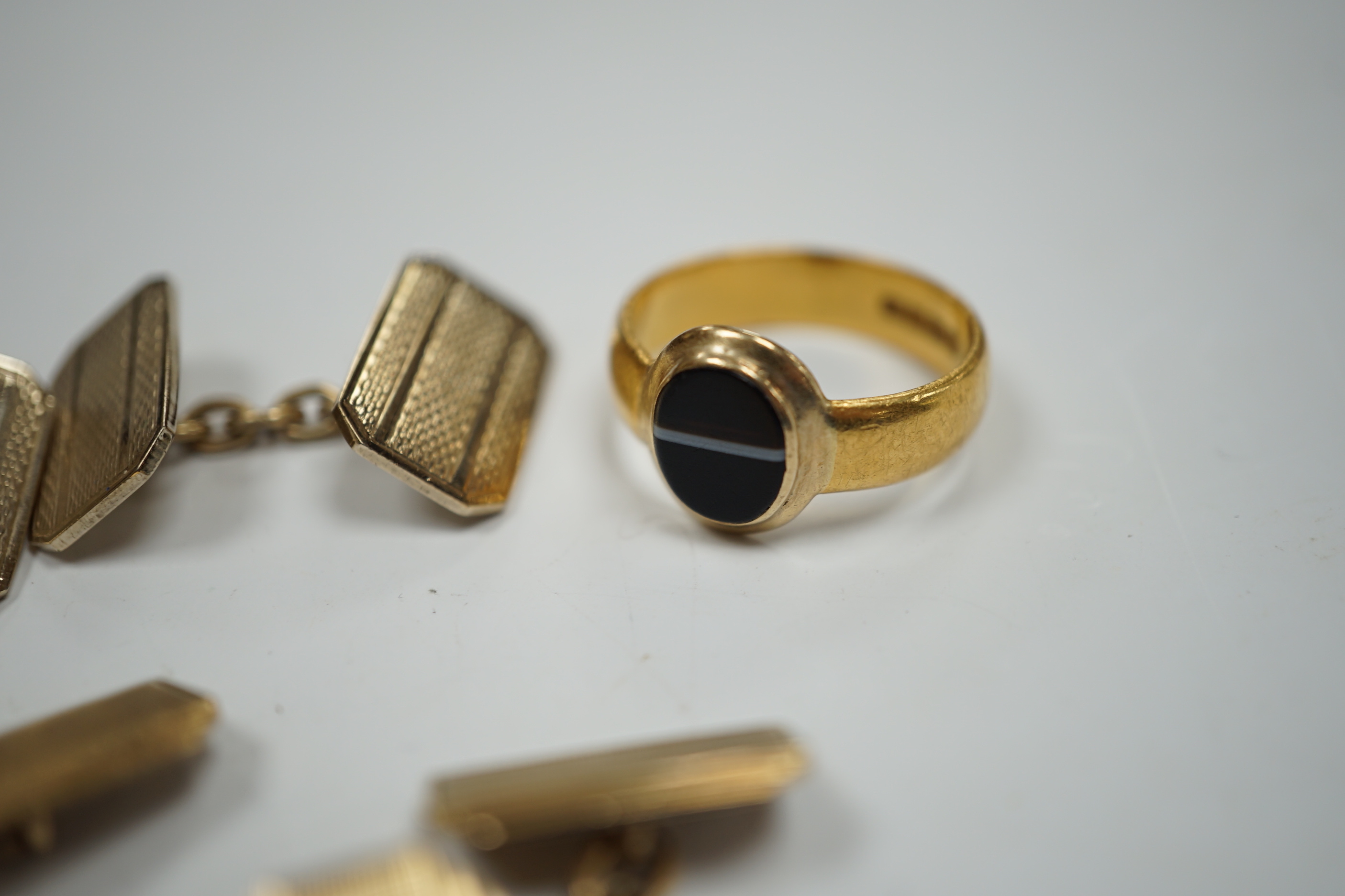 A 1930's part 22ct gold and banded black onyx set signet ring, (the ring head later associated), size Q/R, gross weight 6.8 grams, a pair of engine turned 9ct gold cufflinks, 8.5 grams and one other pair of cufflinks.